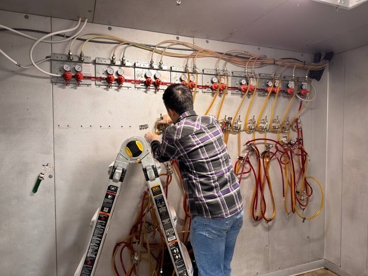 Old beer supply lines being removed inside the cooler area