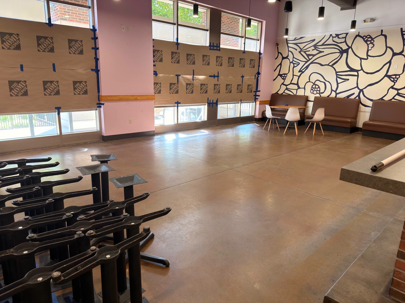 Dining area with new table bases, banquette seating, pendant lights, and decorative wall panels